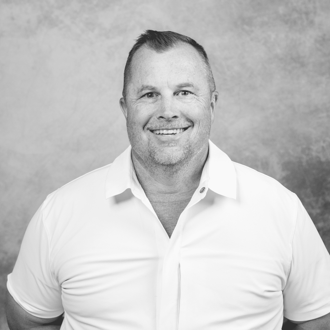 Portrait of a smiling middle-aged man in white shirt